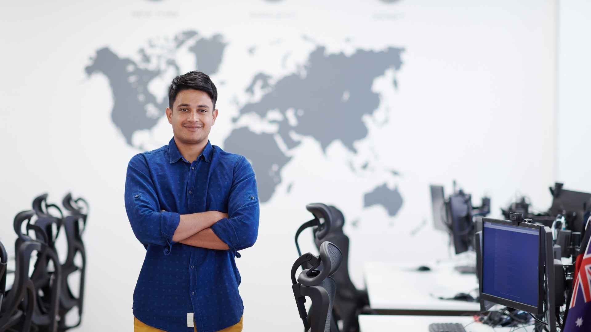 A professional standing in front of a world map